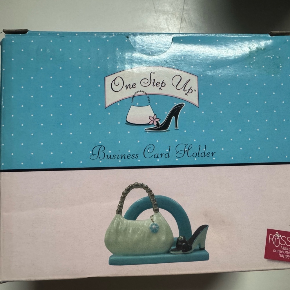This is a Russ Berrie "One Step Up" ceramic business card holder.